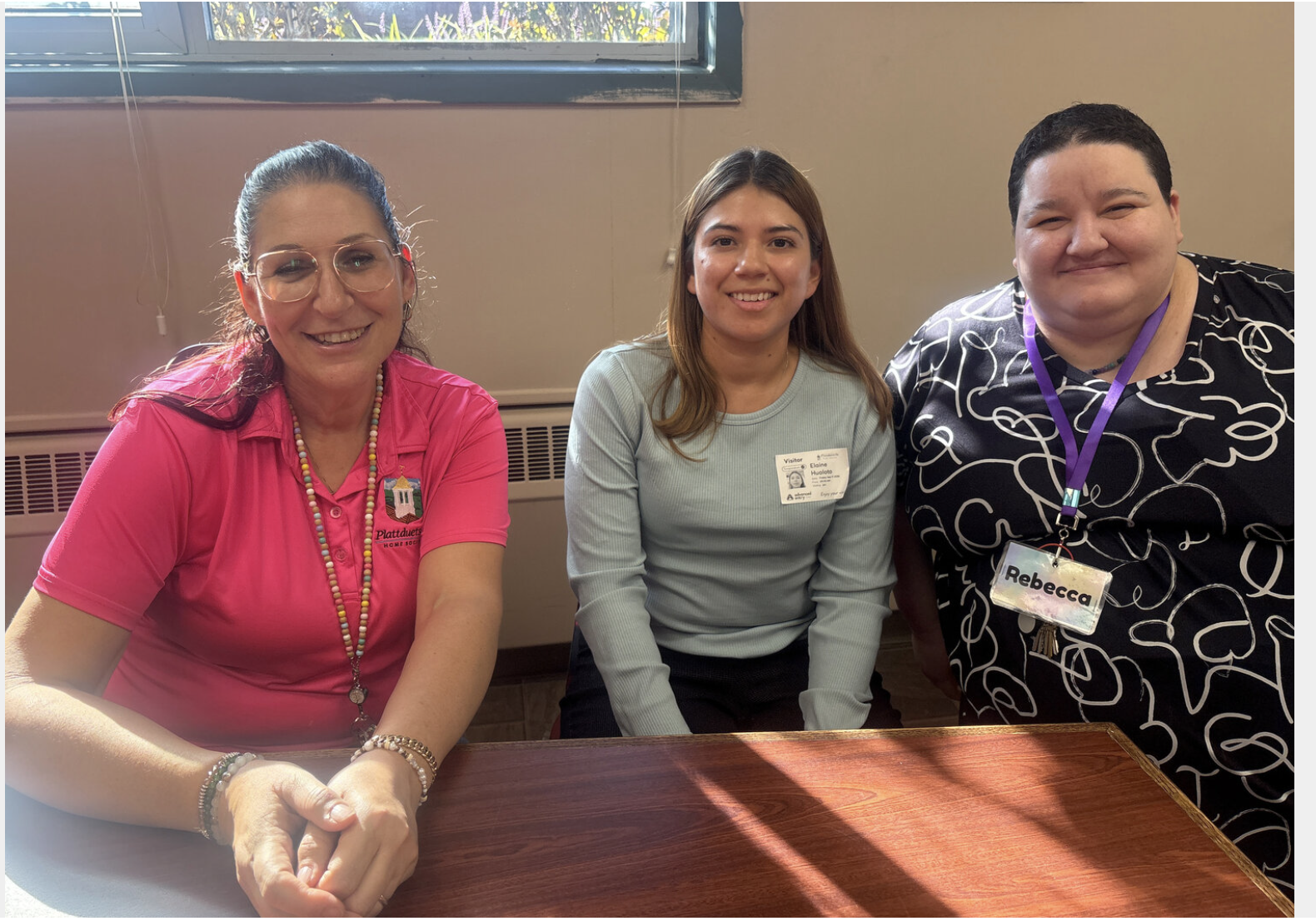 Three women, with student Elaine Hualoto in the center.